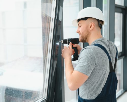 workman-in-overalls-installing-or-adjusting-plasti-UUQURMW workman-in-overalls-installing-or-adjusting-plasti-UUQURMW